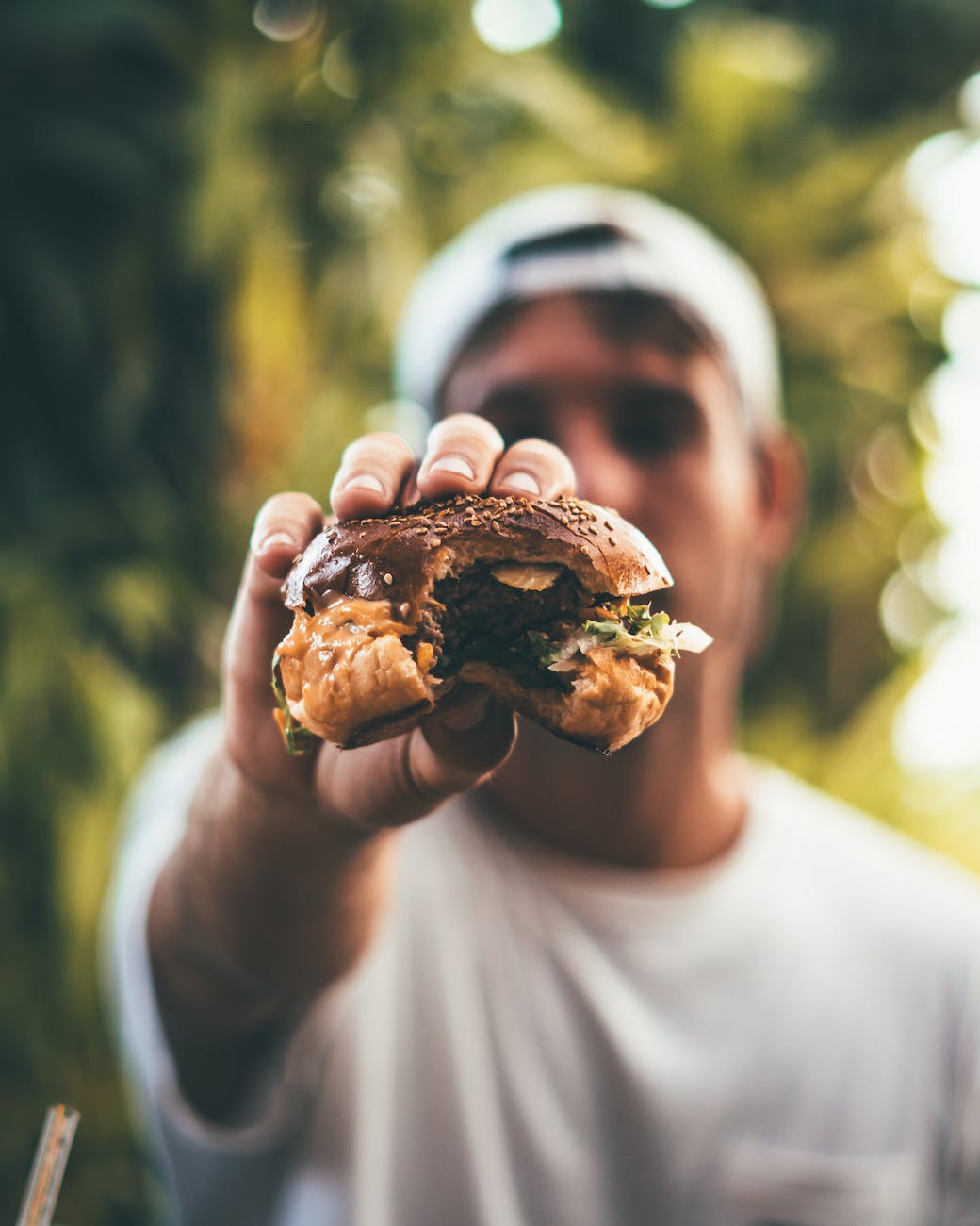 photo of person holding burger